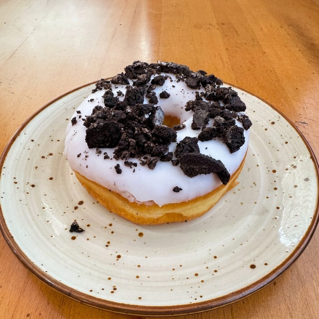 Cookies and cream donut with white glaze and Oreo crumbles